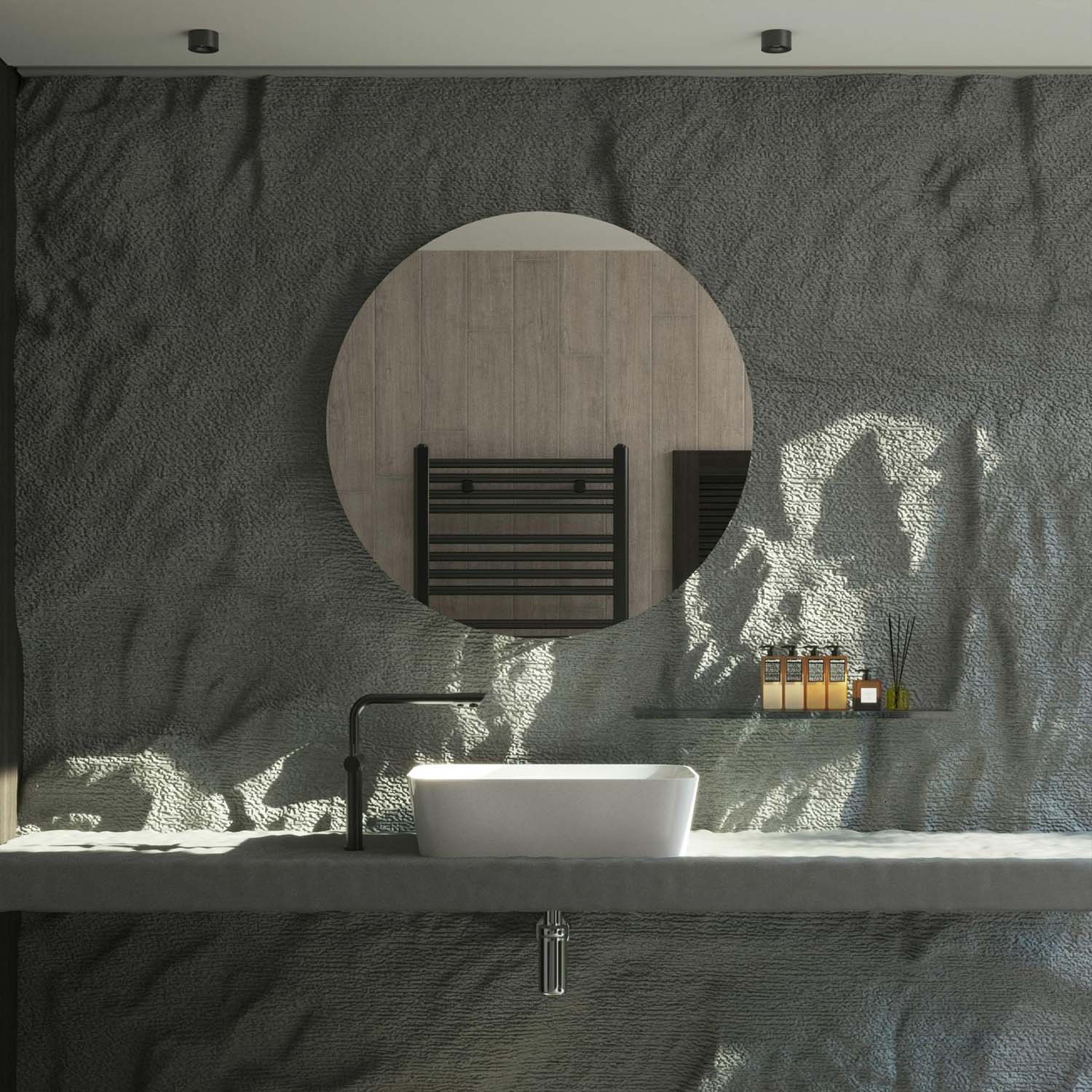 grey stone bathroom wall with circular mirror