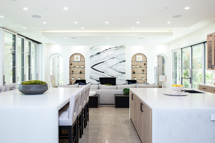 Brightly lit modern open concept kitchen with ample sunlight and Lutron lighting. 