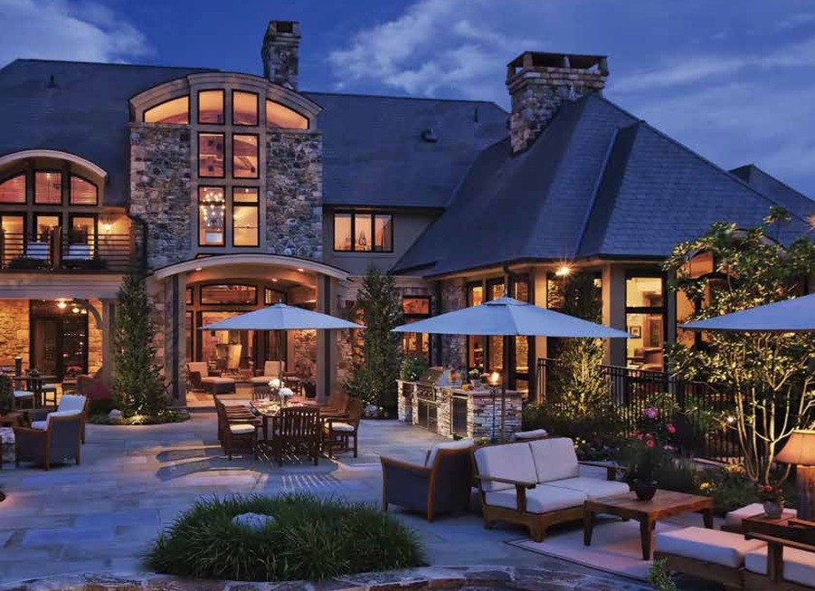 a patio with wooden furniture and outdoor lights.