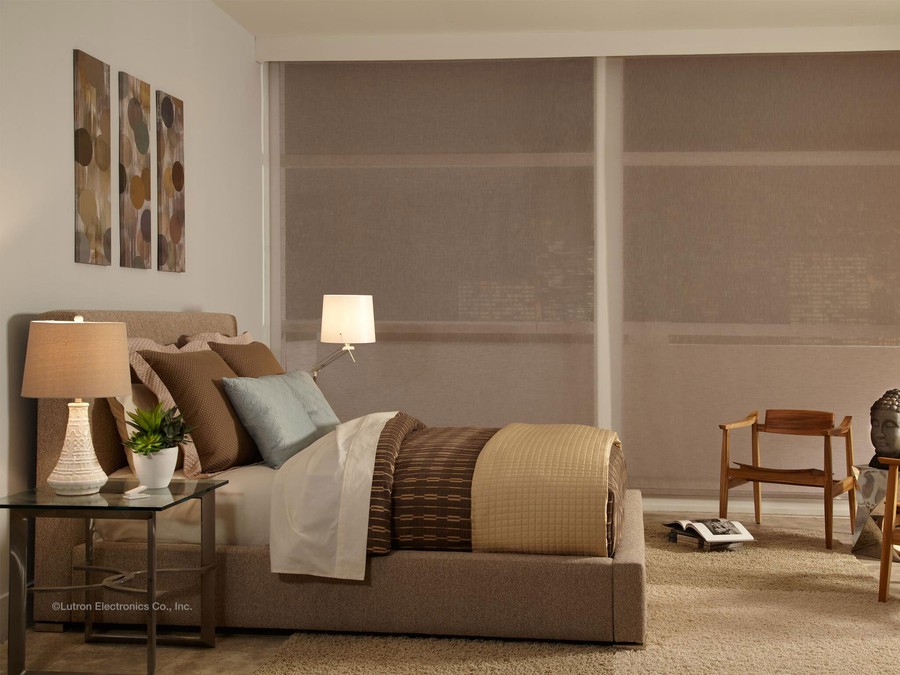 a bedroom with a small wooden chair and side lamps 