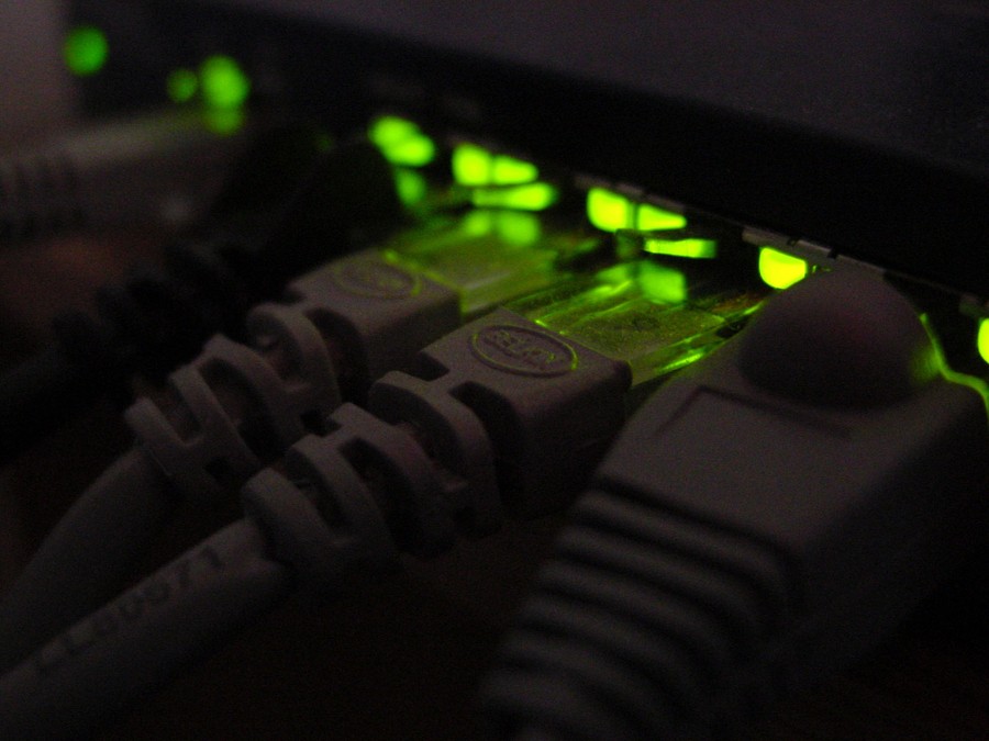 cables connected to a device with green lights 