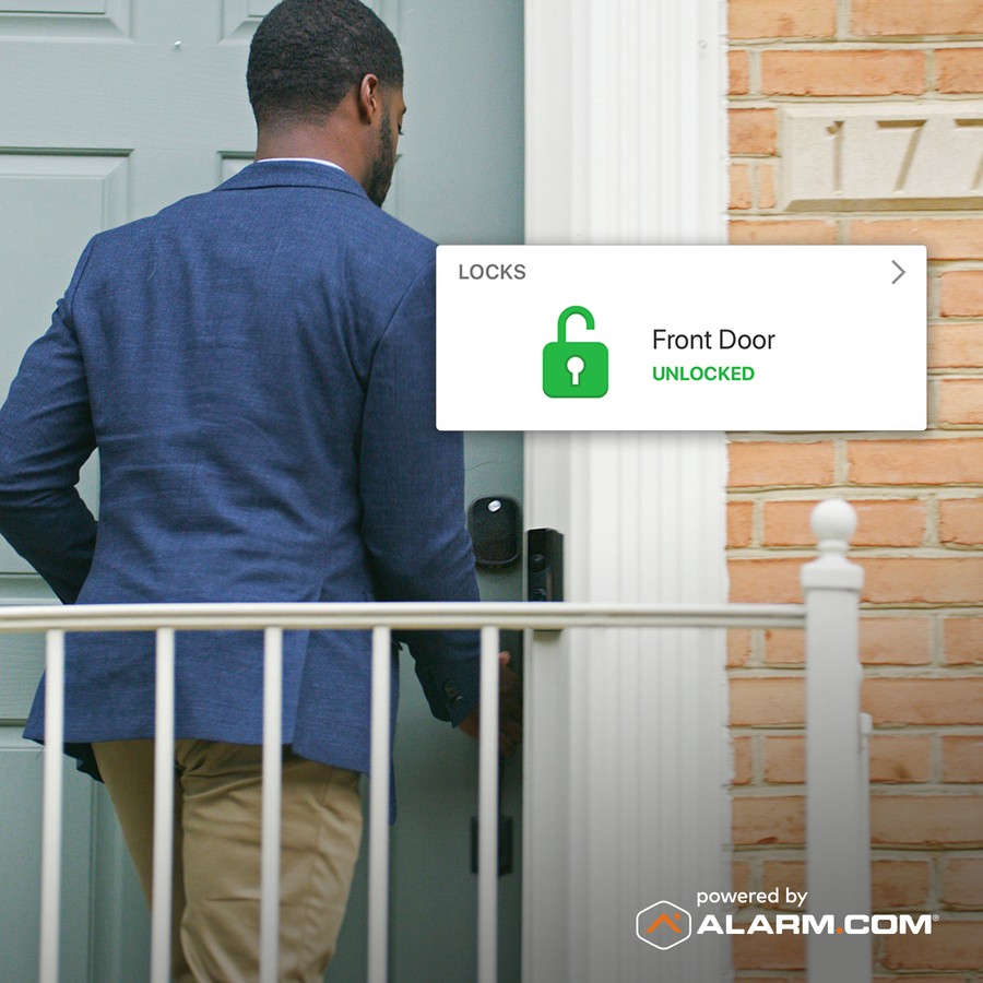 a man unlocking the door to a house with a door entry system 