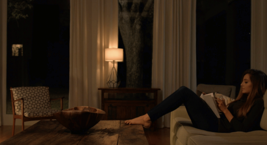 a woman sitting on a sofa in a living room 