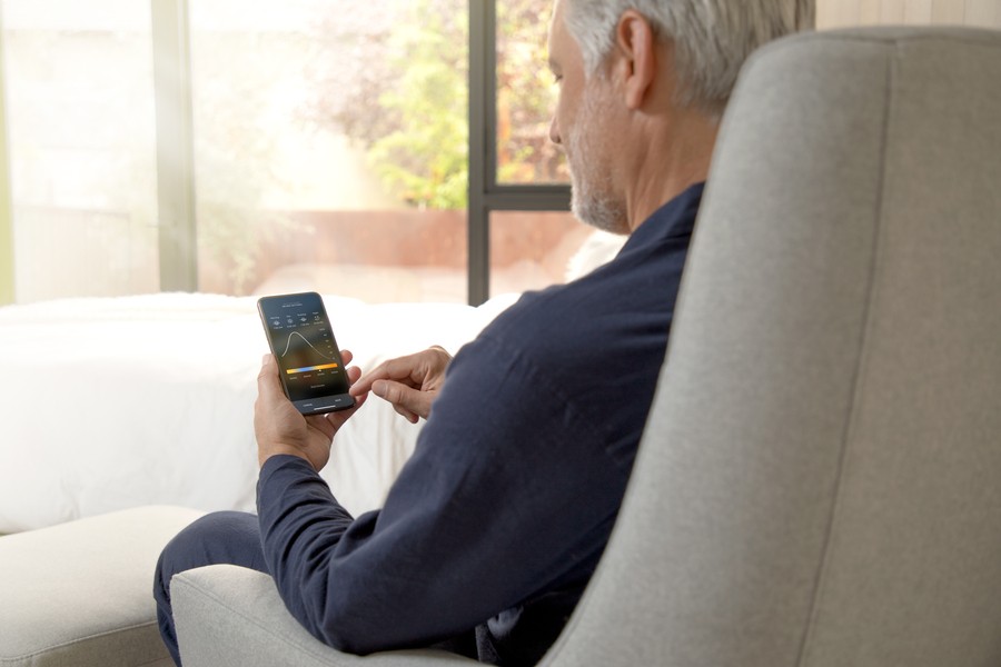 A man using a smart home platform on a mobile phone