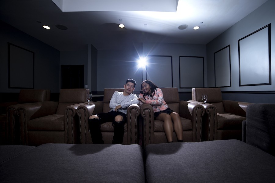 A man and woman in a luxury home theater.